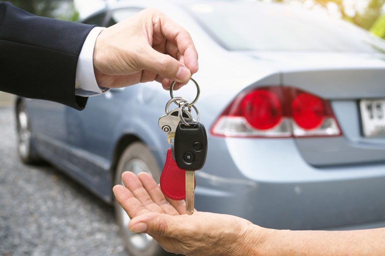 Dealership manager send car keys to the new owner.